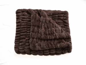 Dark brown luxe blanket, folded with thick textured ridges and plush pile