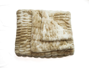 Folded cream faux fur blanket with ribbed marbled pattern and thick pile